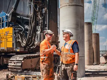 Employees of Bauer Foundations Canada working on a construction site.
